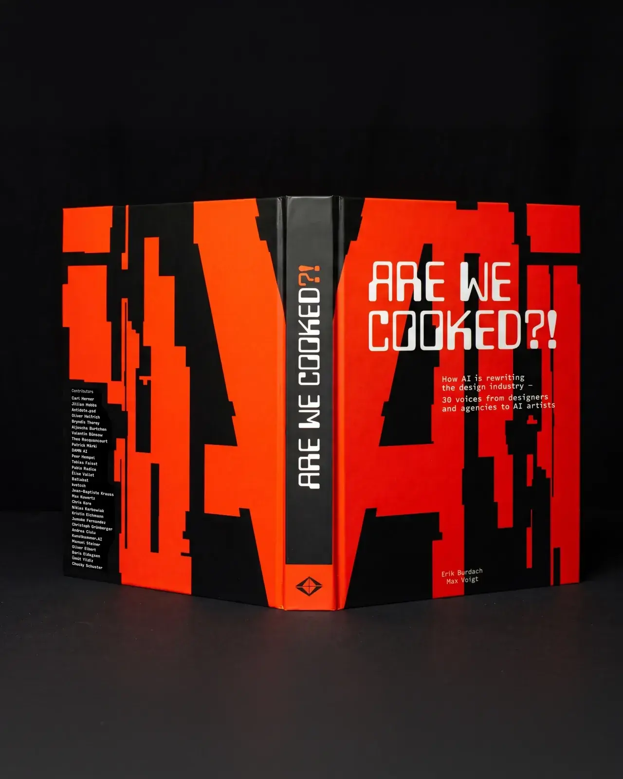 Le livre rouge et noir Are we cooked?! ouvert, photographié sur fond sombre